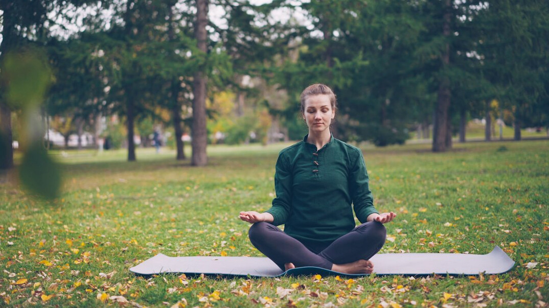 person meditating outdoors